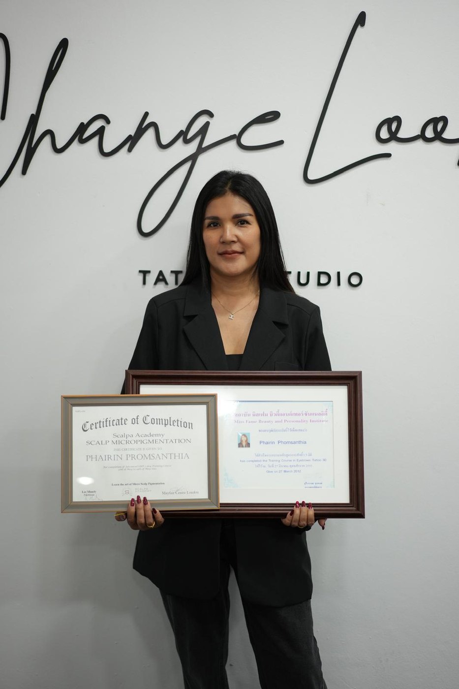 Phairin Promsanthia holding her SMP training certificates at Change Look Studio, Patong